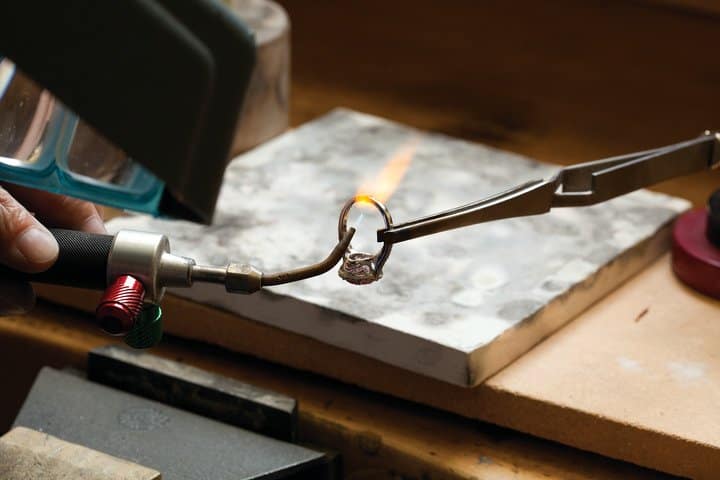 Jeweler making a ring at jewelers bench