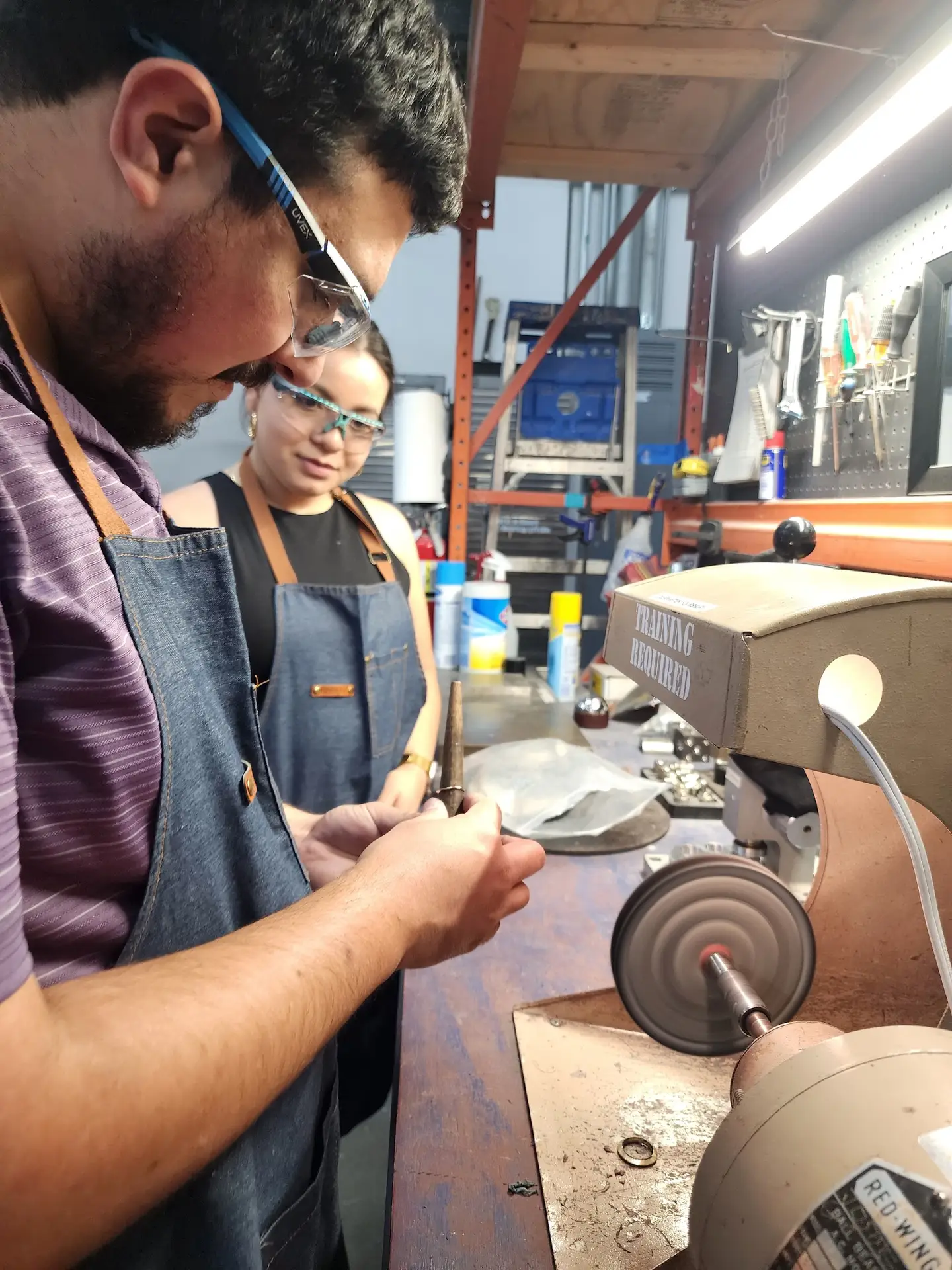 Couple polishing their handmade rings during a ring making class at LaProng in Dallas-Fort Worth